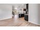 Open living space with hardwood floors and modern kitchen flowing seamlessly at 3314 N Haleyville Ct, Aurora, CO 80019