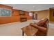 Cozy finished basement with leather sofa, accent wall, carpet, and natural lighting at 3173 Gold Yarrow Ln, Evergreen, CO 80439