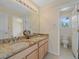 Well-lit bathroom featuring a dual-sink vanity with a marble countertop and a separate toilet room at 3173 Gold Yarrow Ln, Evergreen, CO 80439
