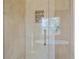 Glass enclosed shower with bright windows and tile work at 3173 Gold Yarrow Ln, Evergreen, CO 80439