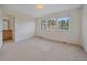 Bright bedroom with large windows offering scenic views and an ensuite bathroom at 3173 Gold Yarrow Ln, Evergreen, CO 80439