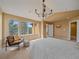 Light filled bedroom with chair, bright windows and natural light at 3173 Gold Yarrow Ln, Evergreen, CO 80439