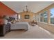 Bright bedroom featuring a large bed, chandelier and windows with amazing views at 3173 Gold Yarrow Ln, Evergreen, CO 80439