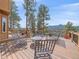Wooden deck with outdoor seating to enjoy mountain views and beautiful landscaping at 3173 Gold Yarrow Ln, Evergreen, CO 80439