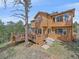 Two-story home featuring a spacious wooden deck and outdoor space, perfect for outdoor enjoyment at 3173 Gold Yarrow Ln, Evergreen, CO 80439
