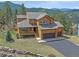 Charming two-story home featuring a front porch and an attached two-car garage at 3173 Gold Yarrow Ln, Evergreen, CO 80439