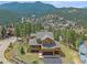 Beautiful exterior of this home featuring professional landscaping, a spacious porch, and a mountain view at 3173 Gold Yarrow Ln, Evergreen, CO 80439