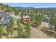 Exterior of home shows mature trees, and a deck, for outdoor living and privacy at 3173 Gold Yarrow Ln, Evergreen, CO 80439