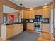 Contemporary kitchen featuring stainless appliances, granite counters, and hardwood floors at 3173 Gold Yarrow Ln, Evergreen, CO 80439