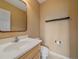 Powder room with a modern vanity, a white sink, and a wall-mounted mirror at 3173 Gold Yarrow Ln, Evergreen, CO 80439