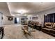 Finished basement featuring leather seating, a unique coffee table and a dart board at 25120 E Maple Pl, Aurora, CO 80018