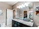 Bright bathroom features a vanity with ample counter space, well-lit mirror, and walk-in closet at 25120 E Maple Pl, Aurora, CO 80018