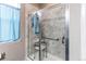 Accessible bathroom featuring a walk-in shower, grab bar, and shower seat for added convenience at 25120 E Maple Pl, Aurora, CO 80018