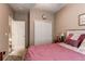 Comfortable bedroom featuring a closet, natural light, and warm neutral walls at 25120 E Maple Pl, Aurora, CO 80018