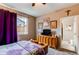 Cozy bedroom with a window, ceiling fan, and ample wall decor at 25120 E Maple Pl, Aurora, CO 80018