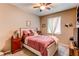 Comfortable bedroom featuring a ceiling fan, natural light, and warm neutral walls at 25120 E Maple Pl, Aurora, CO 80018