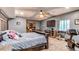 Inviting bedroom featuring a large bed, desk area, and ceiling fan at 25120 E Maple Pl, Aurora, CO 80018