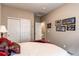 Bright bedroom featuring neutral walls, closet, door to hallway and baseball themed wall art at 25120 E Maple Pl, Aurora, CO 80018