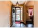 Welcoming entryway features dark wood floors, decorative lighting, and a clear view to the exterior at 25120 E Maple Pl, Aurora, CO 80018
