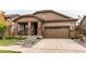 Attractive home featuring a covered porch, stone accents, a two-car garage, and a concrete driveway at 25120 E Maple Pl, Aurora, CO 80018