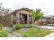 Inviting home exterior with a covered porch, lush landscaping, and a well-maintained lawn at 25120 E Maple Pl, Aurora, CO 80018