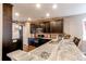 Spacious kitchen with granite countertops, dark cabinetry, and stainless steel appliances at 25120 E Maple Pl, Aurora, CO 80018