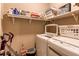 Efficient laundry room with washer, dryer, shelving, cleaning supplies, and storage at 25120 E Maple Pl, Aurora, CO 80018