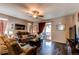 Comfortable living room showcases hardwood floors, ceiling fan, and access to the outdoor patio at 25120 E Maple Pl, Aurora, CO 80018