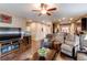 Open-concept living room with hardwood floors, neutral tones, and seamless access to the kitchen area at 25120 E Maple Pl, Aurora, CO 80018