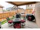 Outdoor patio area featuring a dining set, built-in grill, and wooden fence at 25120 E Maple Pl, Aurora, CO 80018