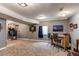 Finished basement with a bar area and entertainment zone including a basketball hoop and dart board at 25120 E Maple Pl, Aurora, CO 80018