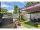 Charming outdoor space featuring a covered pergola, lush greenery, and a relaxing hot tub at 14400 Albrook Dr # 43, Denver, CO 80239