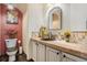 Half bathroom featuring a vessel sink, decorative mirror, and stylish decor at 14400 Albrook Dr # 43, Denver, CO 80239