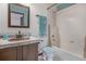 Charming bathroom featuring a tile sink, coordinated accessories, and a shower with a curtain at 14400 Albrook Dr # 43, Denver, CO 80239