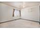 Bedroom features soft carpeting, ceiling fan, and built-in wall shelving for storage at 14400 Albrook Dr # 43, Denver, CO 80239
