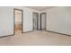 Bedroom with neutral walls and carpets offers versatility and leads to the bathroom and closet at 14400 Albrook Dr # 43, Denver, CO 80239