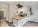 Modern kitchen with white cabinets, tile countertops, and stainless steel appliances at 14400 Albrook Dr # 43, Denver, CO 80239