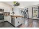 Open concept kitchen with a breakfast bar, stainless steel appliances, and hardwood floors at 14400 Albrook Dr # 43, Denver, CO 80239