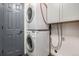 Efficient laundry room features a stacked washer and dryer for space-saving convenience at 14400 Albrook Dr # 43, Denver, CO 80239