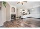 Open concept living area with a cozy fireplace, hardwood floors, and a view of the kitchen at 14400 Albrook Dr # 43, Denver, CO 80239