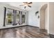 Bright living room with hardwood floors, large windows, and an elegant archway at 14400 Albrook Dr # 43, Denver, CO 80239