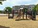 A playground offers a double slide, climbing structures, and a mulch ground covering at 14400 Albrook Dr # 43, Denver, CO 80239