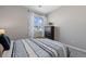 Inviting bedroom featuring neutral walls, a dark dresser, and a calming view at 22610 E Ontario Dr # 204, Aurora, CO 80016