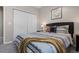 Comfortable bedroom with a patterned duvet, bedside tables, and minimalist decor at 22610 E Ontario Dr # 204, Aurora, CO 80016