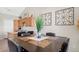 Cozy dining space with a vase centerpiece, decorative wall art, and adjacent kitchen view at 22610 E Ontario Dr # 204, Aurora, CO 80016
