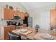 Functional kitchen featuring stainless steel appliances, breakfast bar, and ample counter space for meal preparation at 22610 E Ontario Dr # 204, Aurora, CO 80016