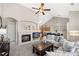 Cozy living room features a fireplace, TV, comfortable seating and high ceilings, perfect for relaxing and entertaining at 22610 E Ontario Dr # 204, Aurora, CO 80016