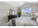 Spacious primary bedroom with a view, dark wood dresser, and a comfortable king bed at 22610 E Ontario Dr # 204, Aurora, CO 80016