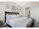 Serene primary bedroom with a large bed, modern decor, and an open ensuite bathroom at 22610 E Ontario Dr # 204, Aurora, CO 80016