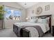 Inviting primary bedroom featuring a king bed, natural light, and neutral color palette at 22610 E Ontario Dr # 204, Aurora, CO 80016